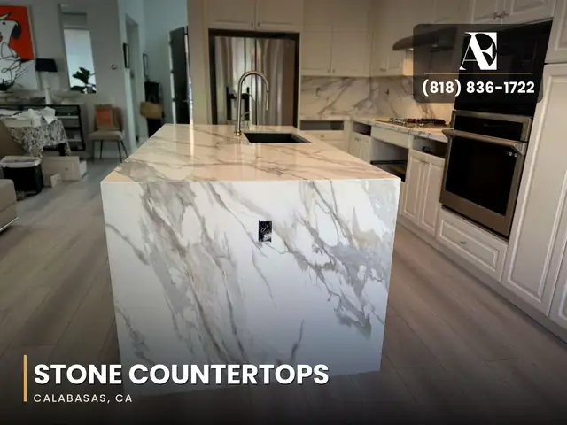 Calabasas kitchen with white cabinets, a marble-look stone island and a full-height stone backsplash
